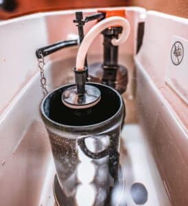 toilet tank open to check float and flapper for cause of running toilet